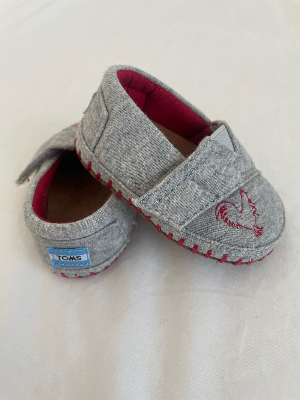 Toms Grey Slip-On Baby Shoes with Red Accents and Rooster Stitch (NWOT) size 2